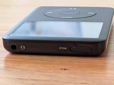Custom iPod Classic 7th Gen 1TB with 3000mAh battery, all black, top with headphone jack and hold switch